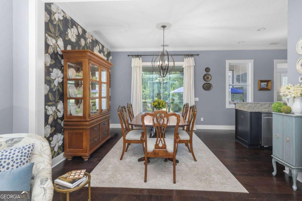 106 Boatsman Way St. Marys, GA 31558 - Photo 17 of 52 a dining room with furniture a chandelier and wooden floor