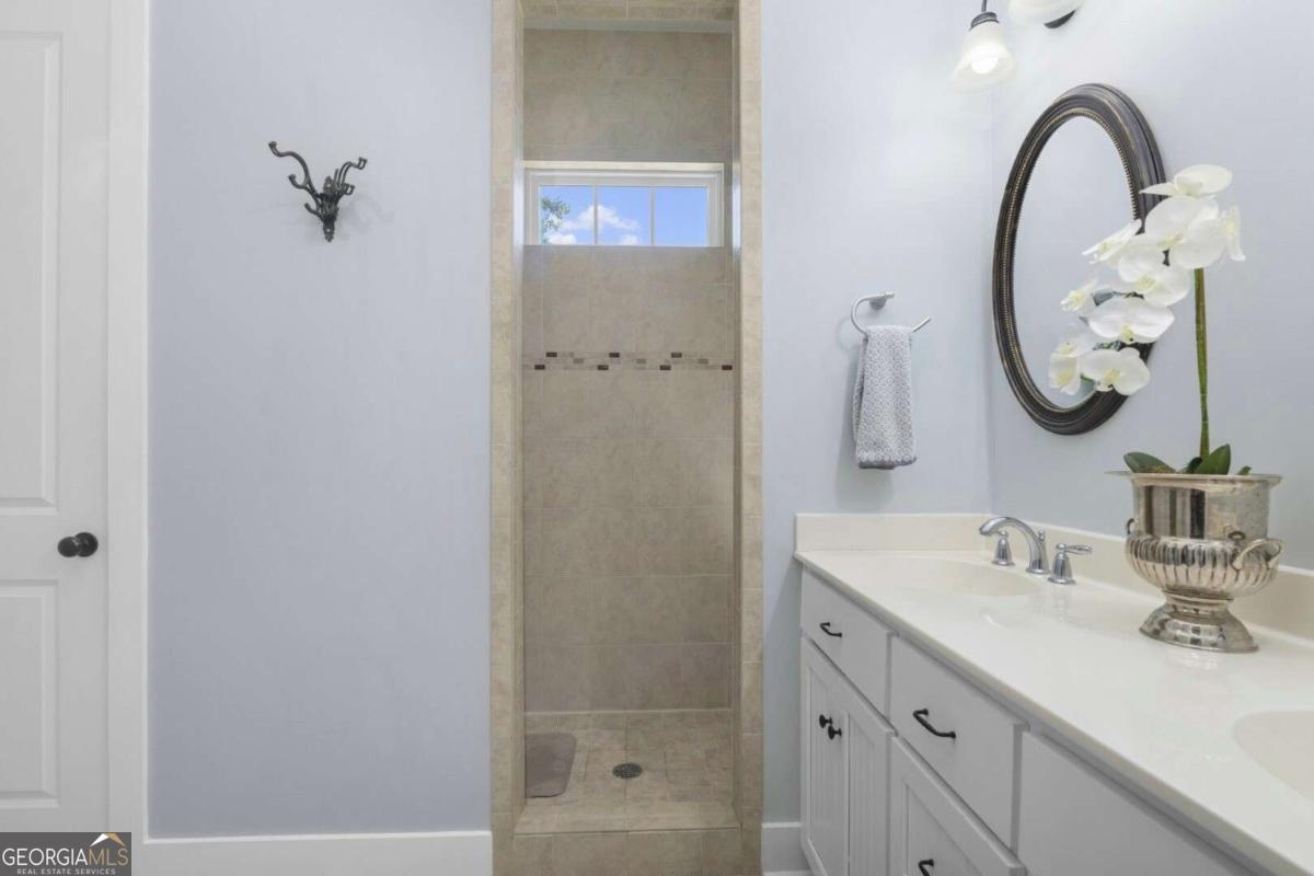 106 Boatsman Way St. Marys, GA 31558 - Photo 23 of 52 a bathroom with a sink and a mirror