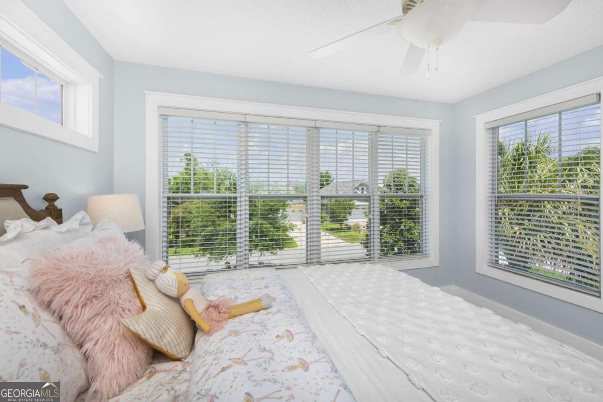 106 Boatsman Way St. Marys, GA 31558 - Photo 27 of 52 a bedroom with a large bed and a large window