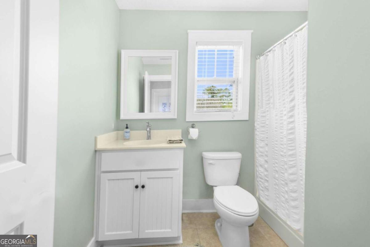 106 Boatsman Way St. Marys, GA 31558 - Photo 30 of 52 a bathroom with a toilet sink and mirror