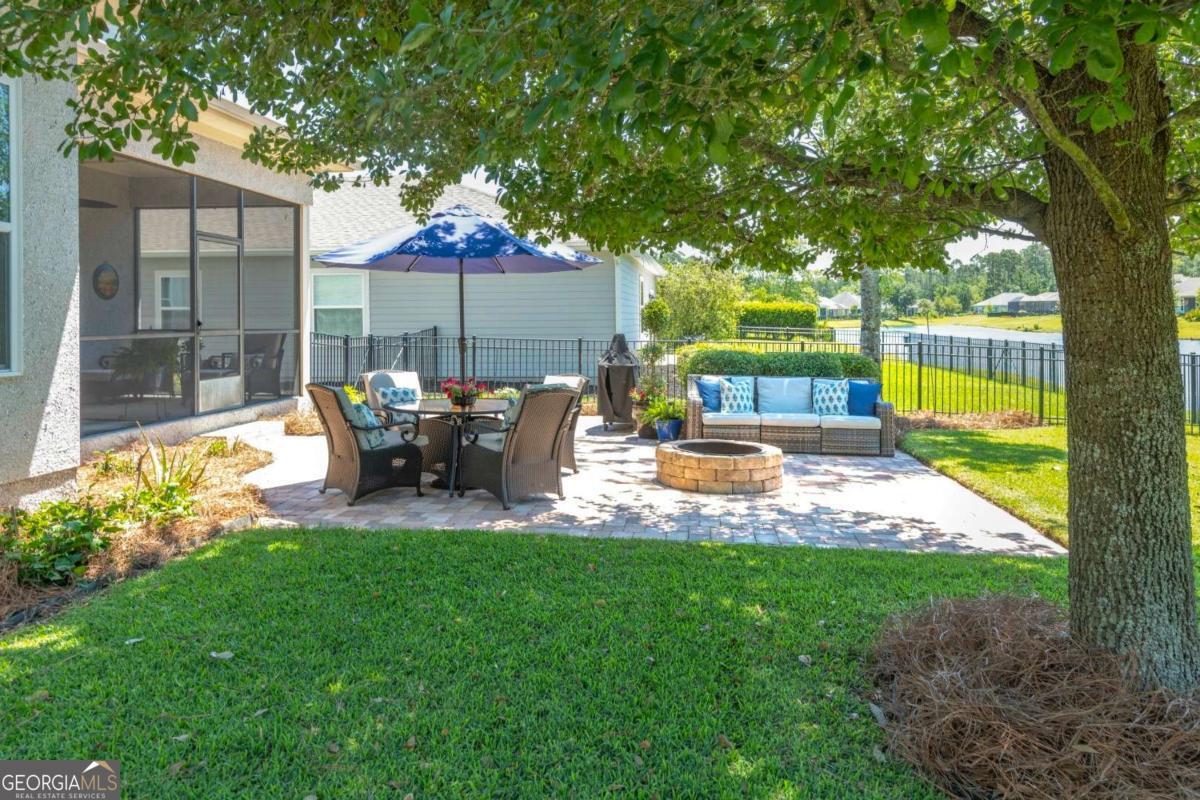 106 Boatsman Way St. Marys, GA 31558 - Photo 37 of 52 a view of a patio with table chairs and a backyard