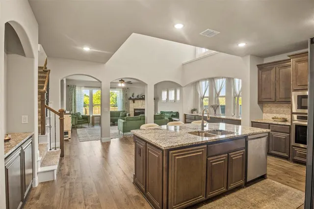 a kitchen with sink stove and refrigerator