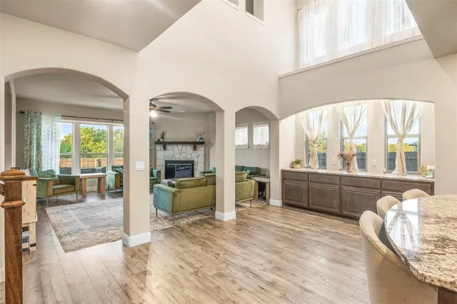 a view of living room kitchen with furniture and windows