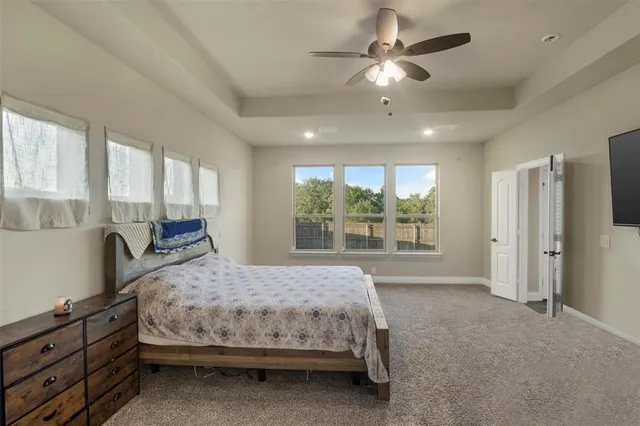 a bedroom with a large bed and a large window