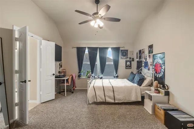 a bedroom with bed and a chandelier