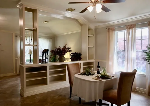 a dining room with furniture and window