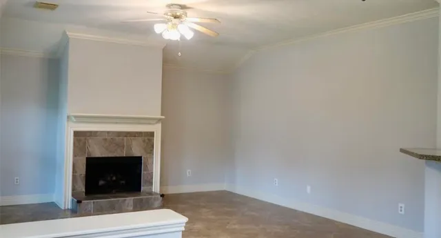a living room with a fireplace and chandelier
