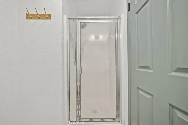 a bathroom with a glass shower door