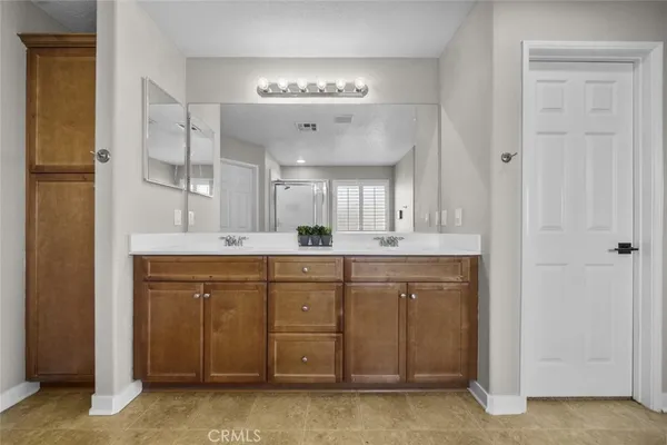 a spacious bathroom with a mirror a sink and a mirror