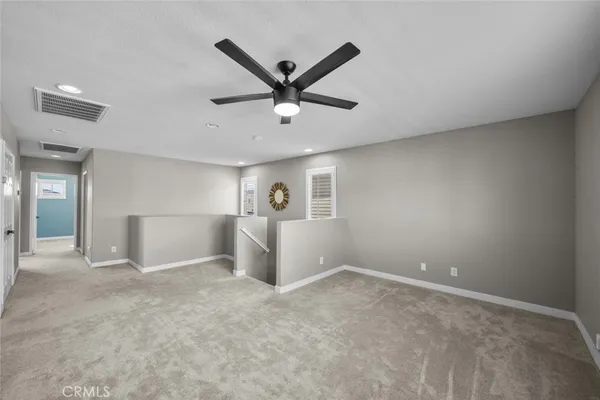 a view of a livingroom with a ceiling fan and window