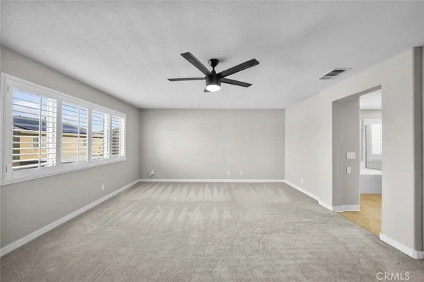 a view of a livingroom with a ceiling fan and window