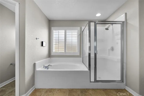 a bathroom with a bathtub and a shower
