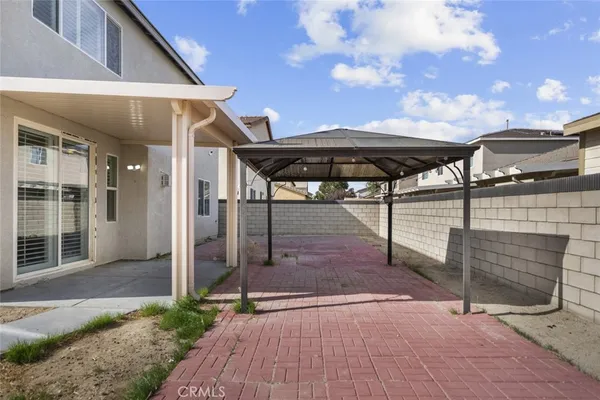 a view of a patio with table and chairs with wooden floor and fence