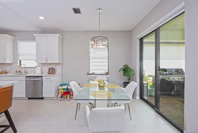 a dining room with a window and chandelier
