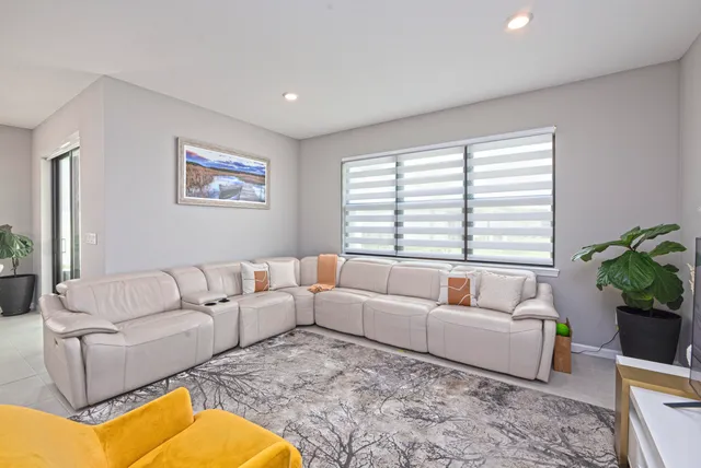 a living room with furniture and a potted plant