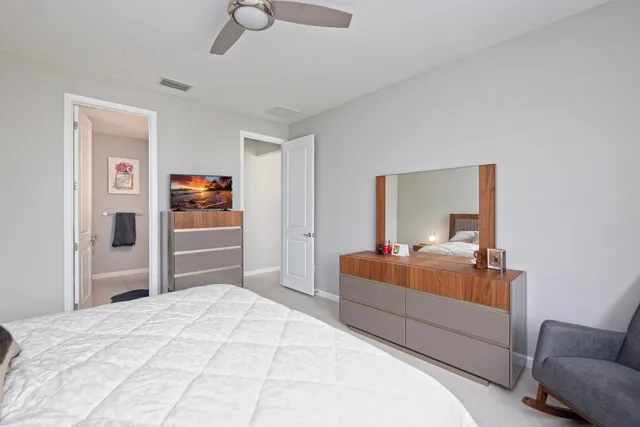 a bedroom with a bed and dresser