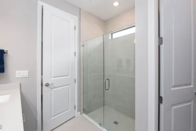 a bathroom with a glass shower door