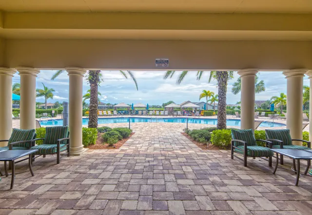 a view of swimming pool with outdoor seating and plants