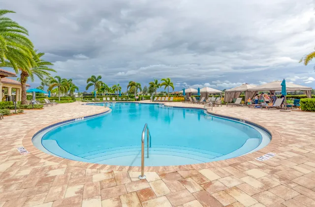 a view of a swimming pool with an outdoor seating and a tub
