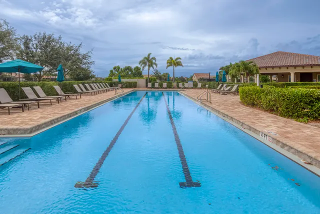 a view of swimming pool with outdoor seating and plants