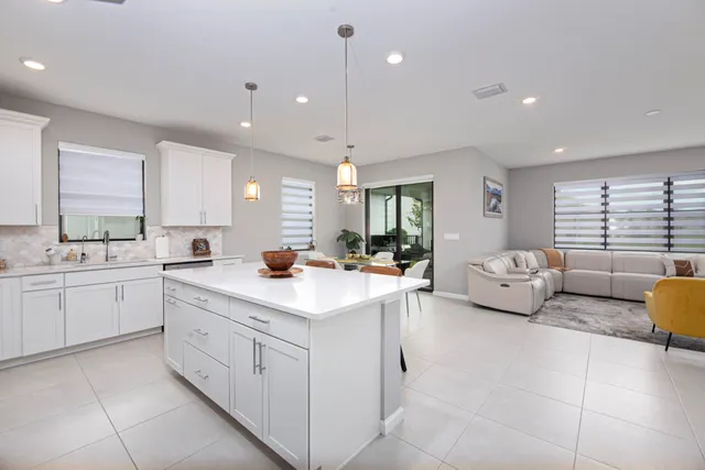 a large white kitchen with a large window