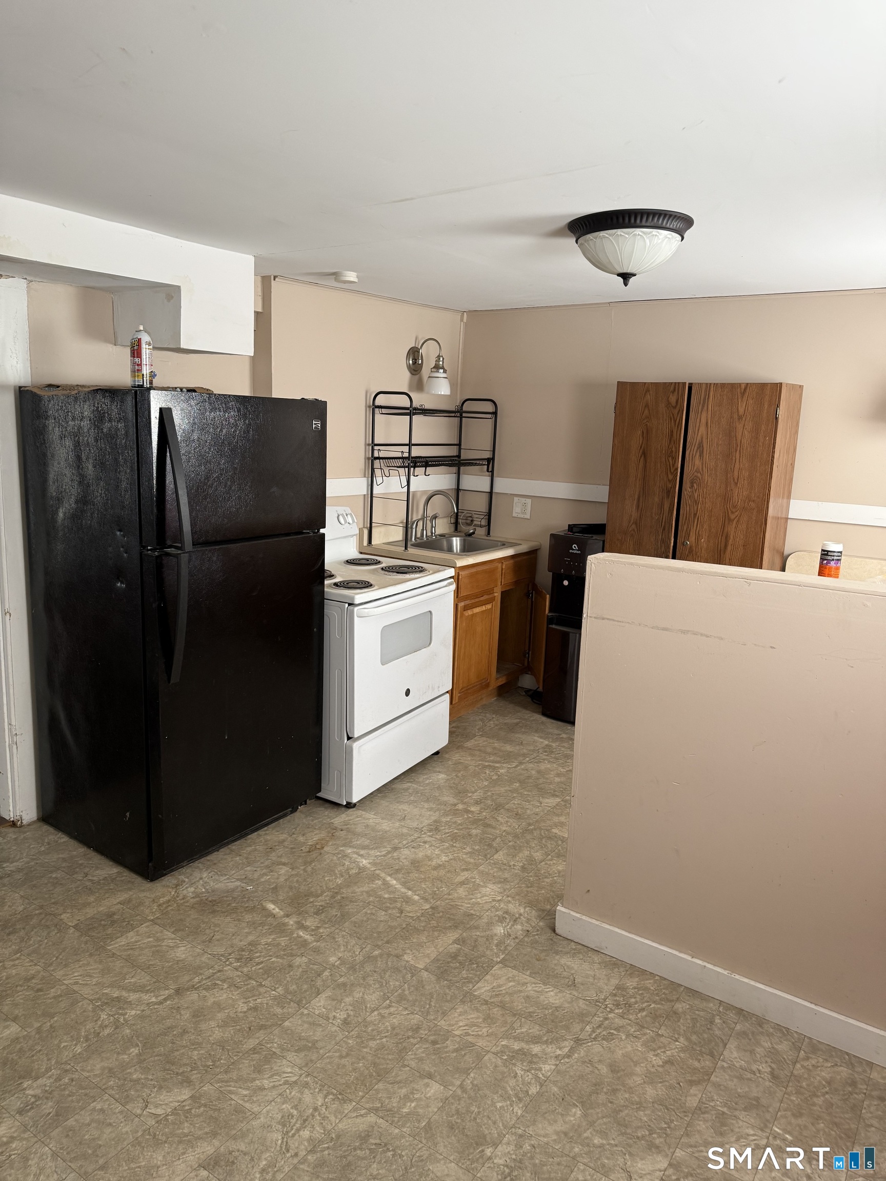67 Summer Street Bristol, CT 06010 - Photo 13 of 31 a kitchen with refrigerator and cabinets