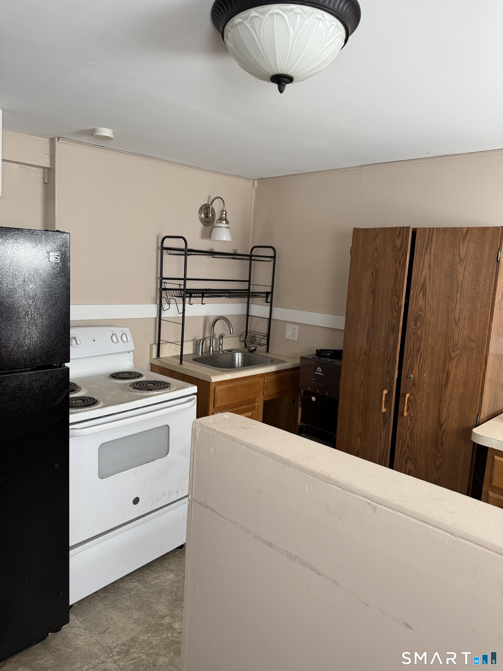 67 Summer Street Bristol, CT 06010 - Photo 17 of 31 a kitchen with stainless steel appliances granite countertop a sink a stove and refrigerator