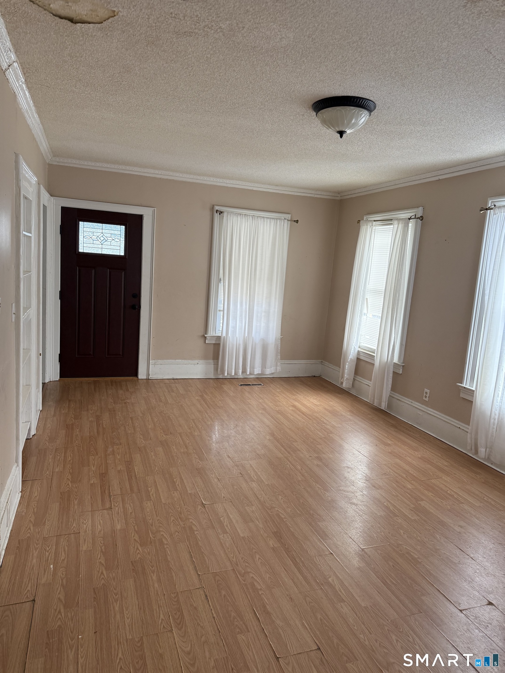 67 Summer Street Bristol, CT 06010 - Photo 21 of 31 an empty room with wooden floor and windows