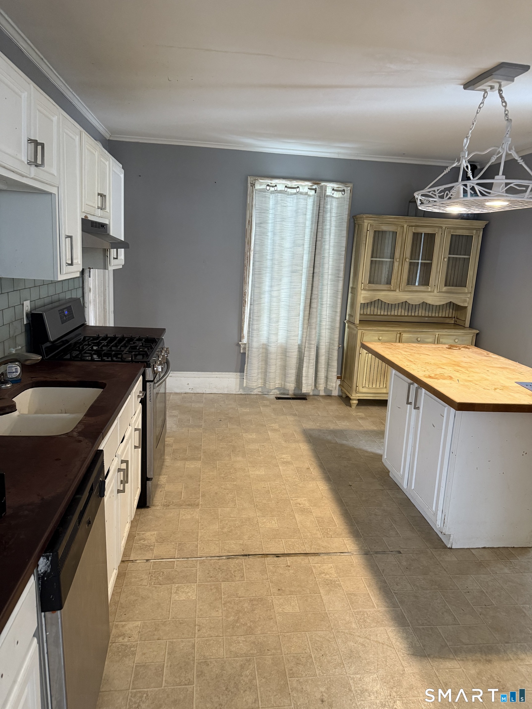 67 Summer Street Bristol, CT 06010 - Photo 24 of 31 a kitchen with stainless steel appliances granite countertop a stove a sink and a refrigerator
