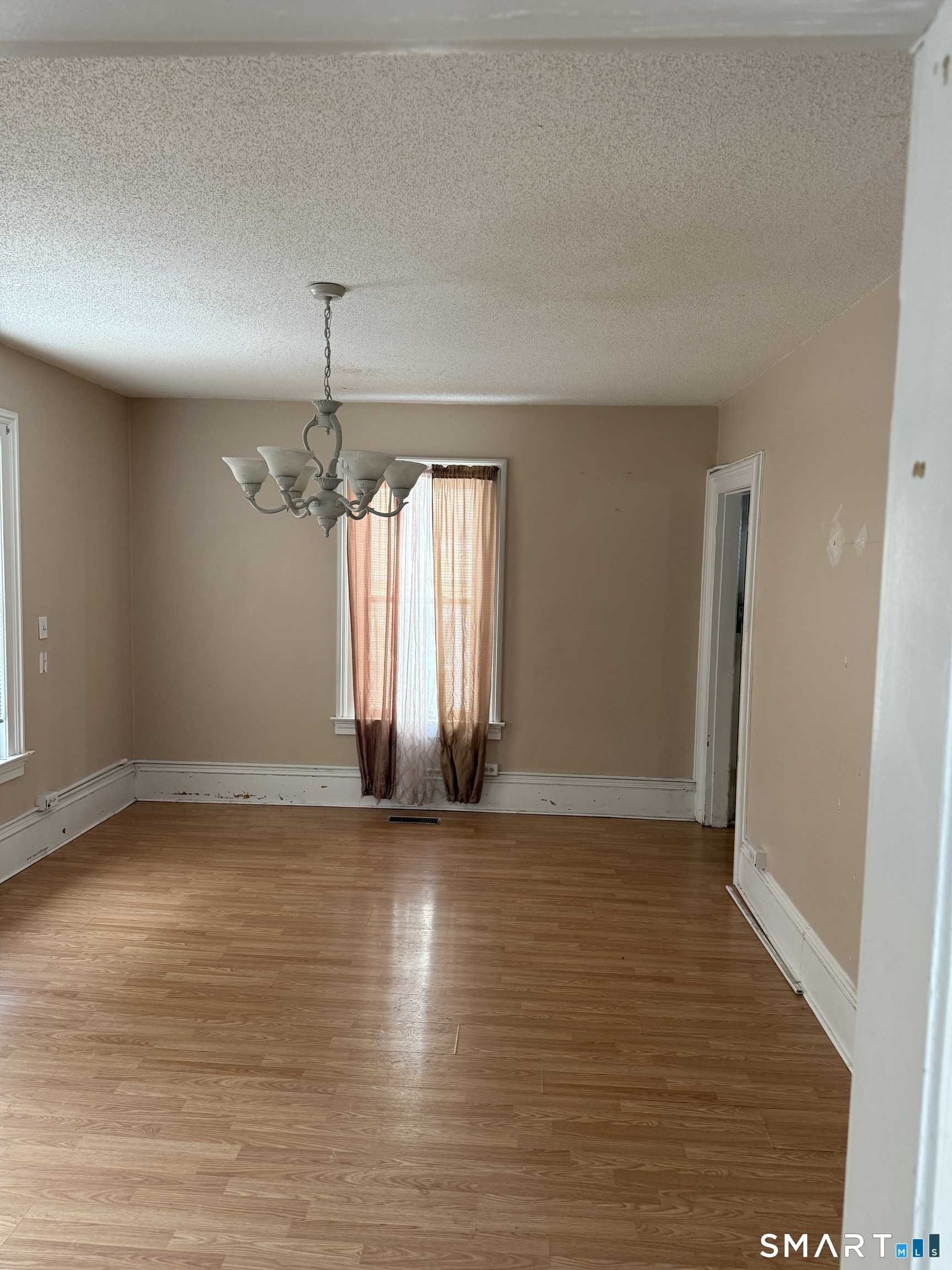 67 Summer Street Bristol, CT 06010 - Photo 25 of 31 an empty room with wooden floor and windows