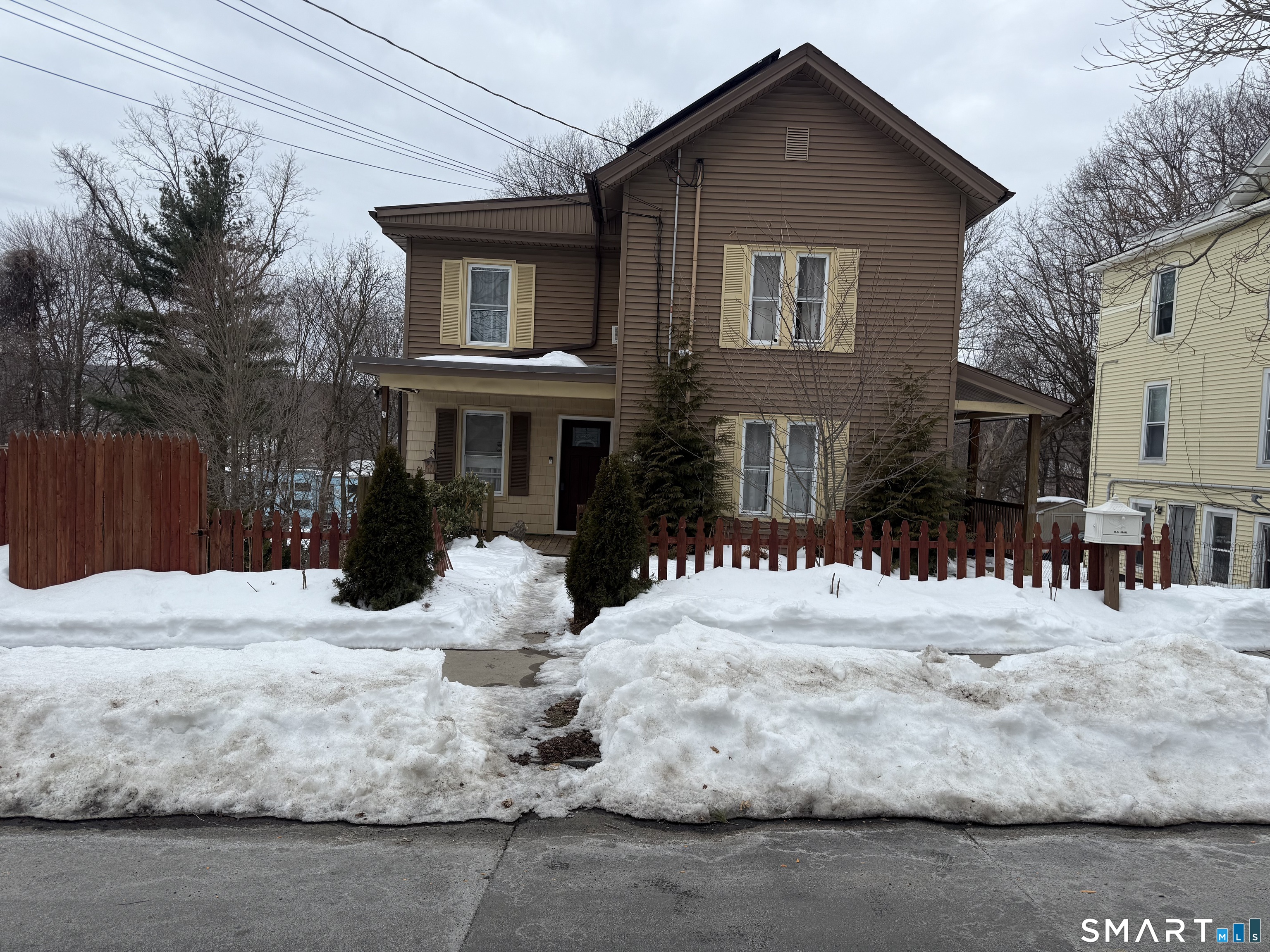 67 Summer Street Bristol, CT 06010 - Photo 31 of 31 a front view of a house with a yard covered in snow
