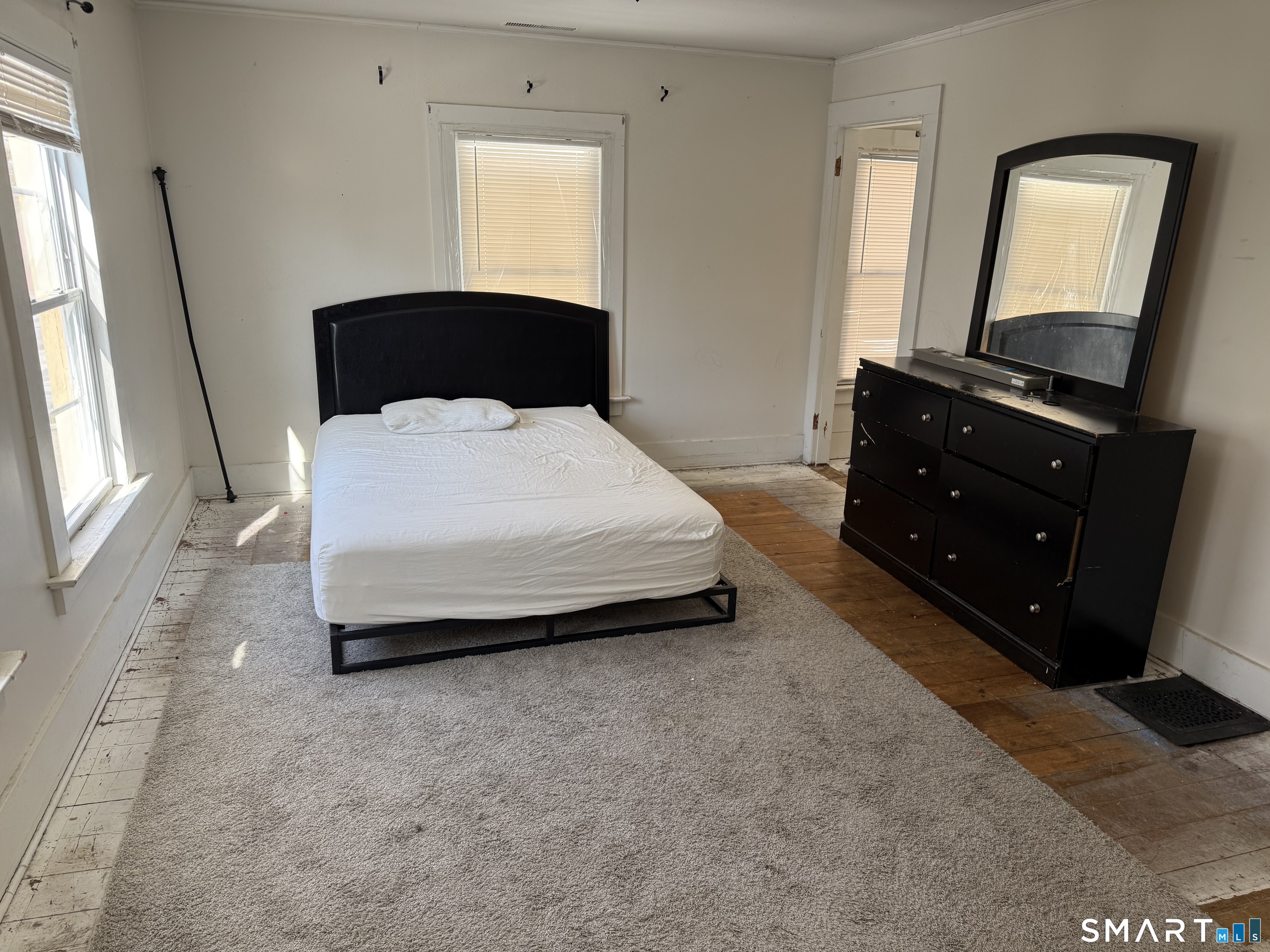 67 Summer Street Bristol, CT 06010 - Photo 6 of 31 a bedroom with a bed and a flat tv screen on dresser