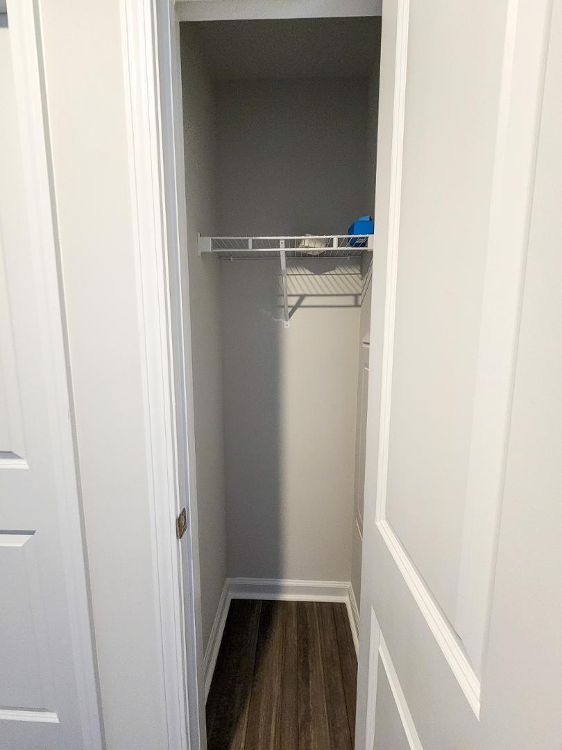 2431 Kasota Lane Raleigh, NC 27610 - Photo 11 of 59 a view of walk in closet with wooden floor