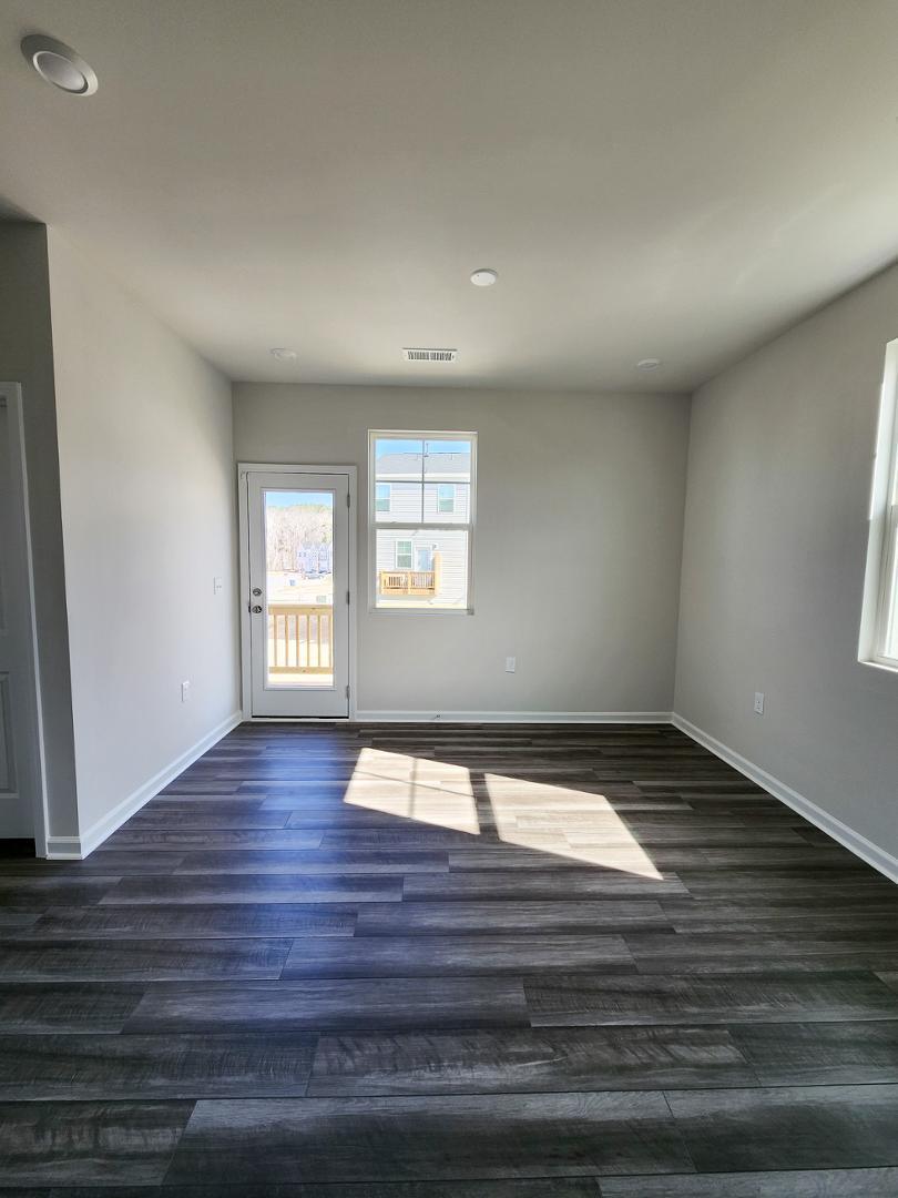 2431 Kasota Lane Raleigh, NC 27610 - Photo 18 of 59 a view of an empty room with wooden floor and a window