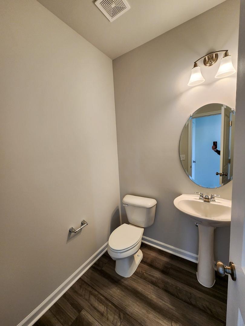 2431 Kasota Lane Raleigh, NC 27610 - Photo 19 of 59 a bathroom with a toilet sink and mirror