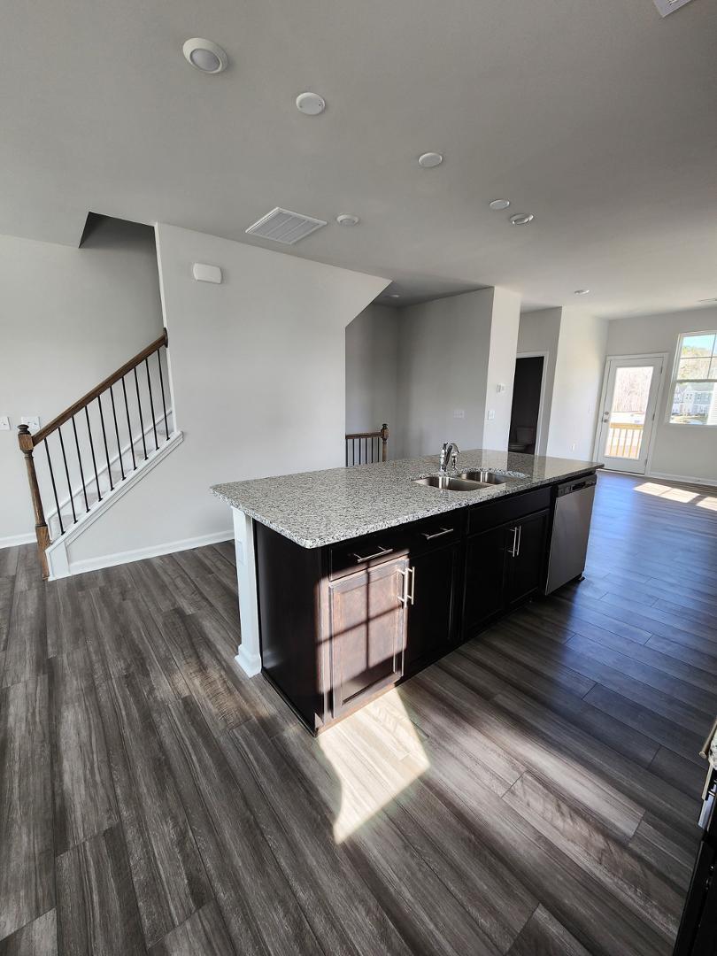 2431 Kasota Lane Raleigh, NC 27610 - Photo 26 of 59 a kitchen with a sink a counter top space and cabinets