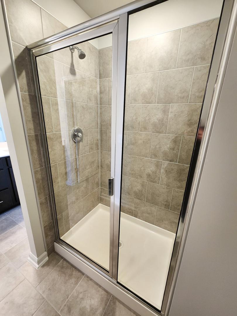 2431 Kasota Lane Raleigh, NC 27610 - Photo 40 of 59 a bathroom with a glass door shower and sink