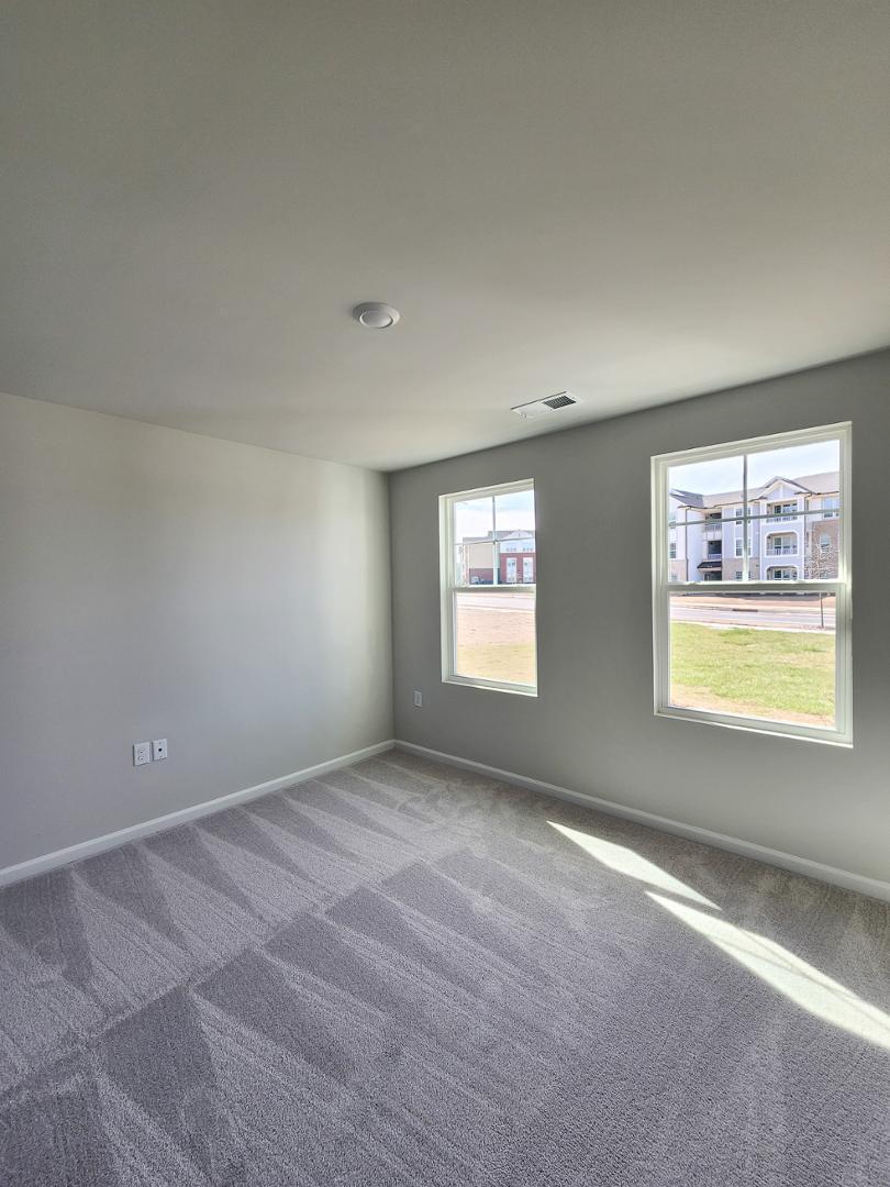 2431 Kasota Lane Raleigh, NC 27610 - Photo 4 of 59 an empty room with windows