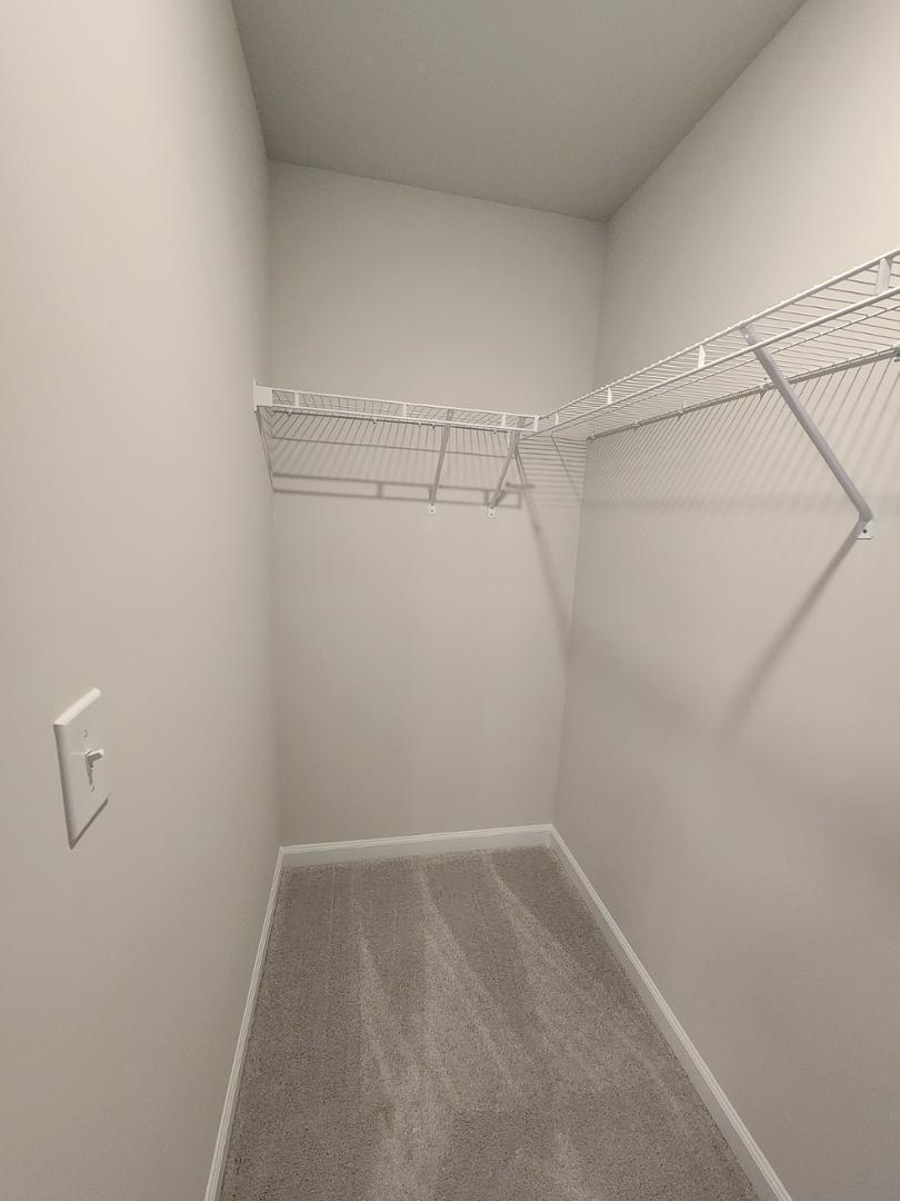 2431 Kasota Lane Raleigh, NC 27610 - Photo 41 of 59 a view of a room with racks on the wall