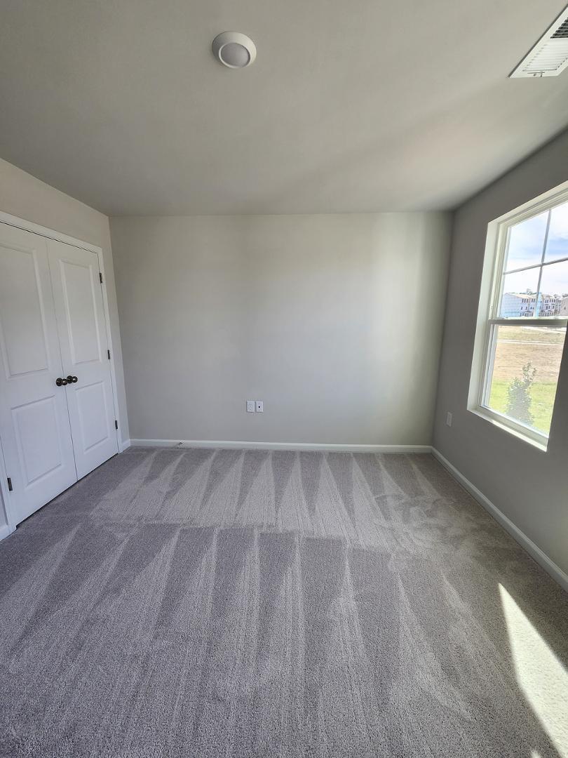 2431 Kasota Lane Raleigh, NC 27610 - Photo 5 of 59 a view of a room with wooden floor and windows in a room