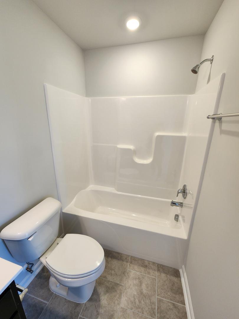 2431 Kasota Lane Raleigh, NC 27610 - Photo 52 of 59 a bathroom with a toilet and a bath tub