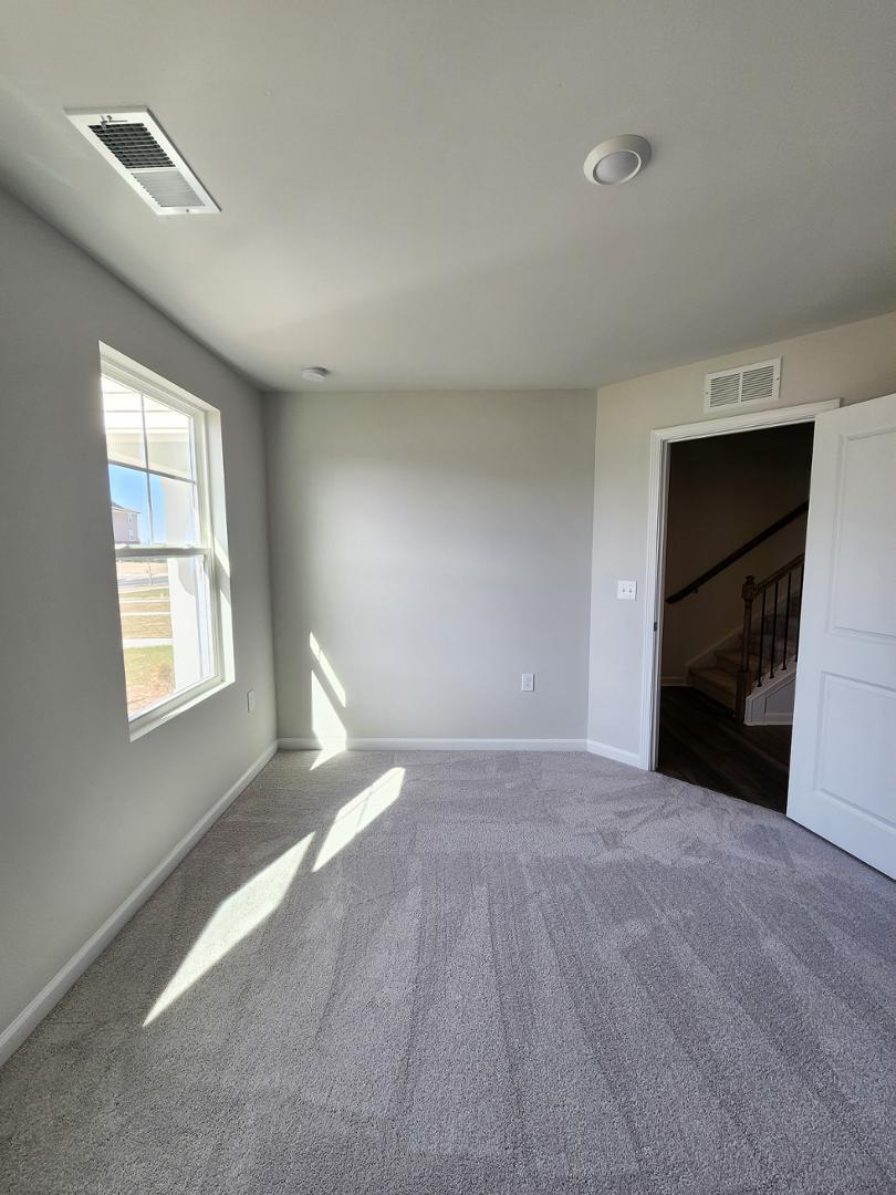 2431 Kasota Lane Raleigh, NC 27610 - Photo 7 of 59 a view of empty room with a fireplace and window