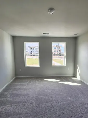 a view of walk in closet with wooden floor
