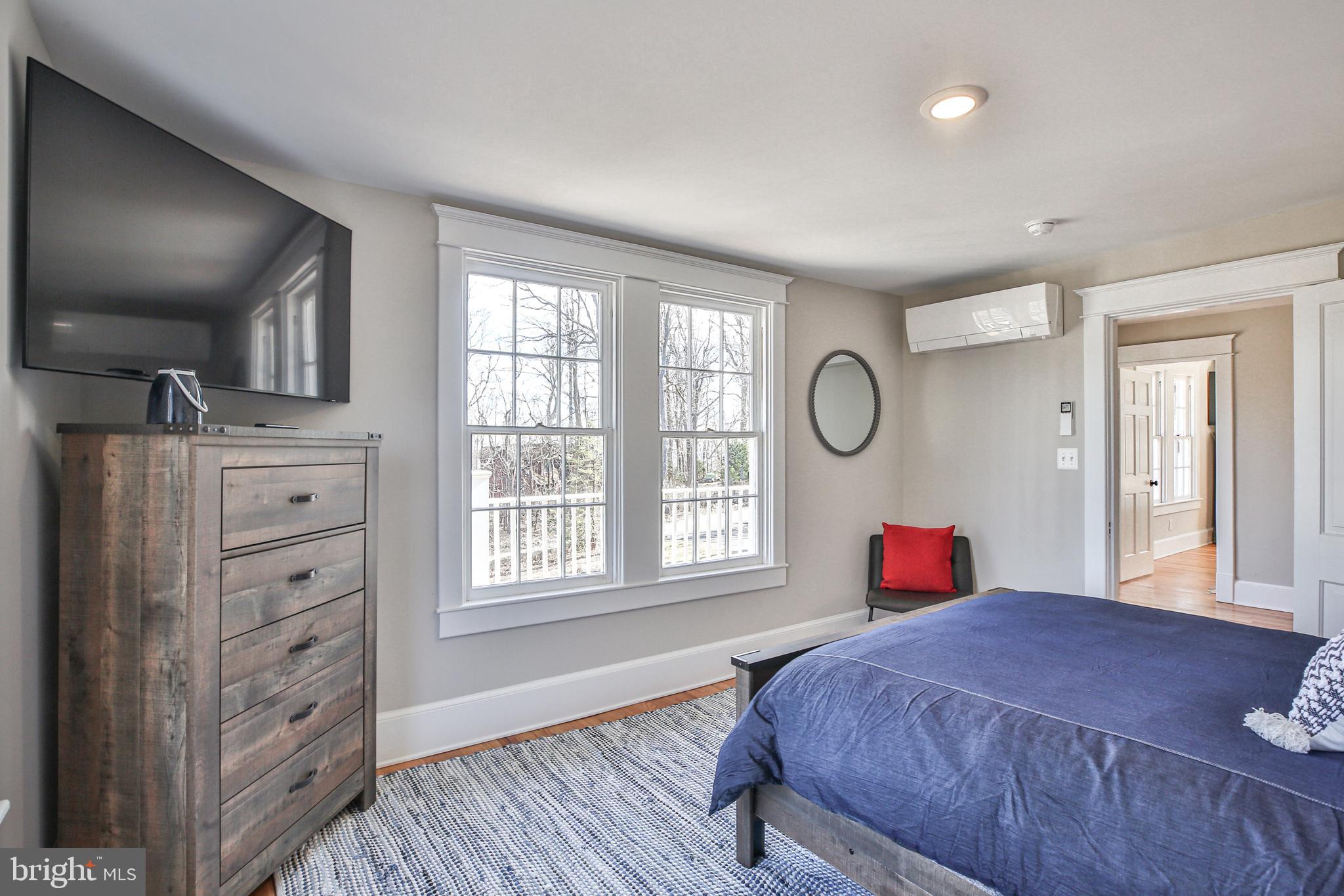 17345 Raven Rocks Road Bluemont, VA 20135 - Photo 65 of 99 a bedroom with a bed and a dresser next to a window
