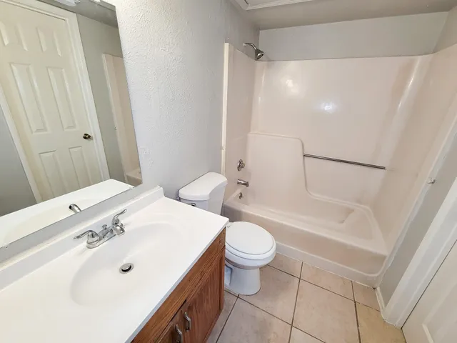 a bathroom with a sink a toilet and a bathtub