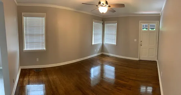 wooden floor in an empty room with a window