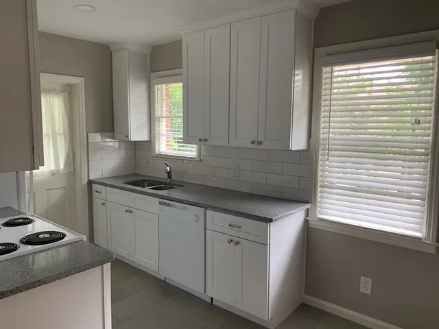 a kitchen that has a sink and a stove