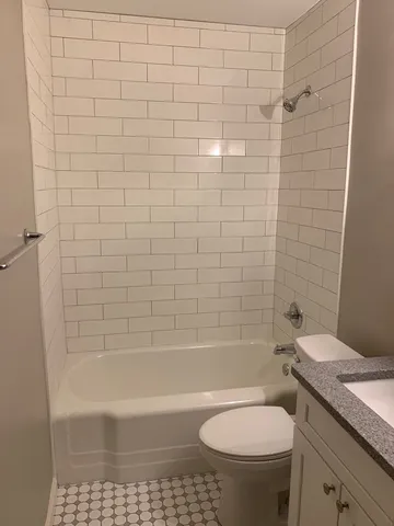 a bathroom with a bathtub and a toilet