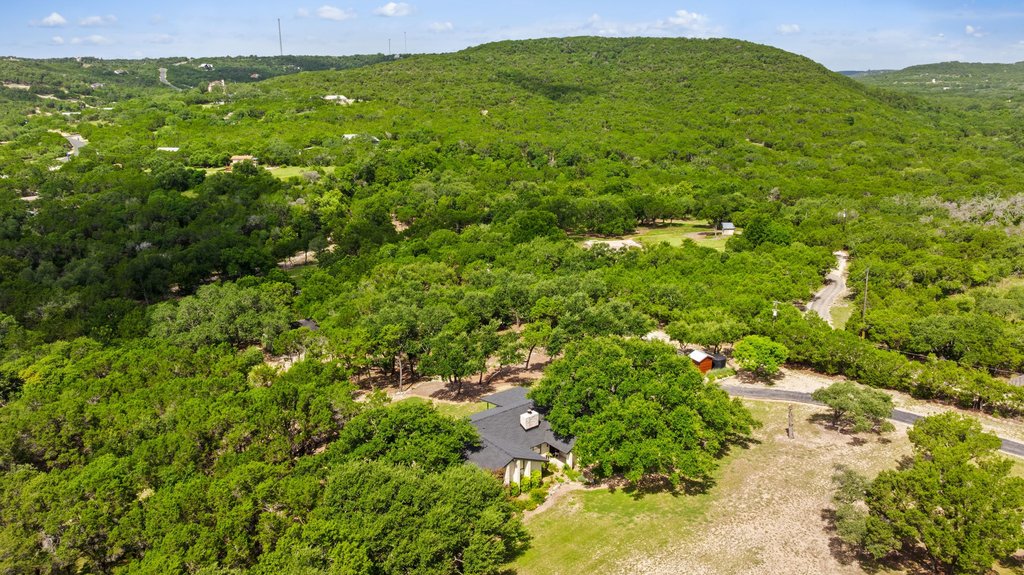 23644 Nameless Road Leander, TX 78641 - Photo 33 of 40 Perched on a verdant hillside, this private home nestles amidst an abundance of mature trees.
