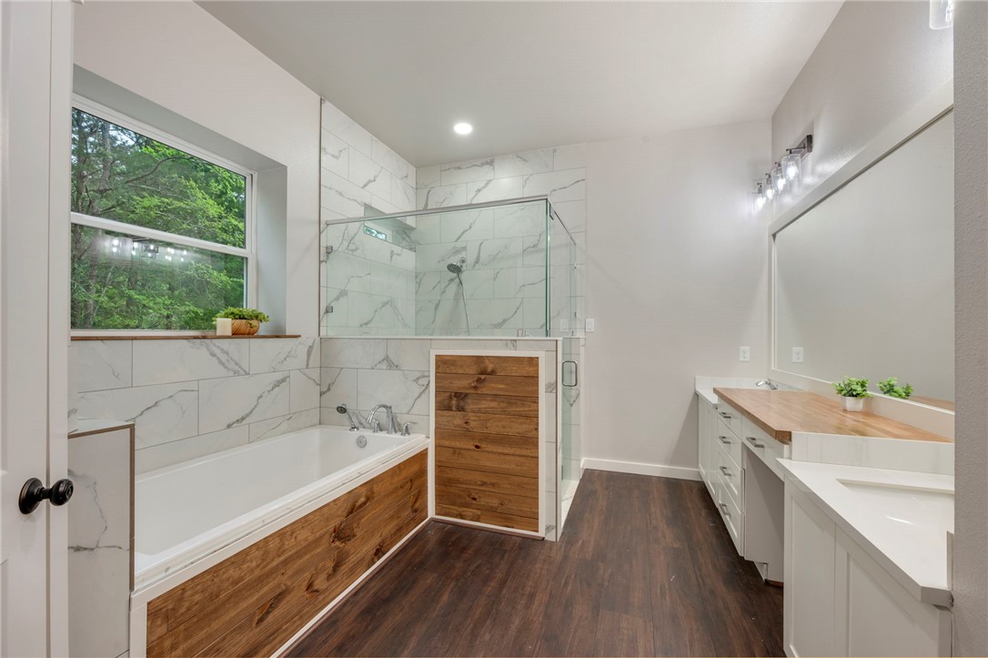 3915 County Road 447 Anderson, TX 77830 - Photo 13 of 40 a bathroom with a bathtub sink and a shower